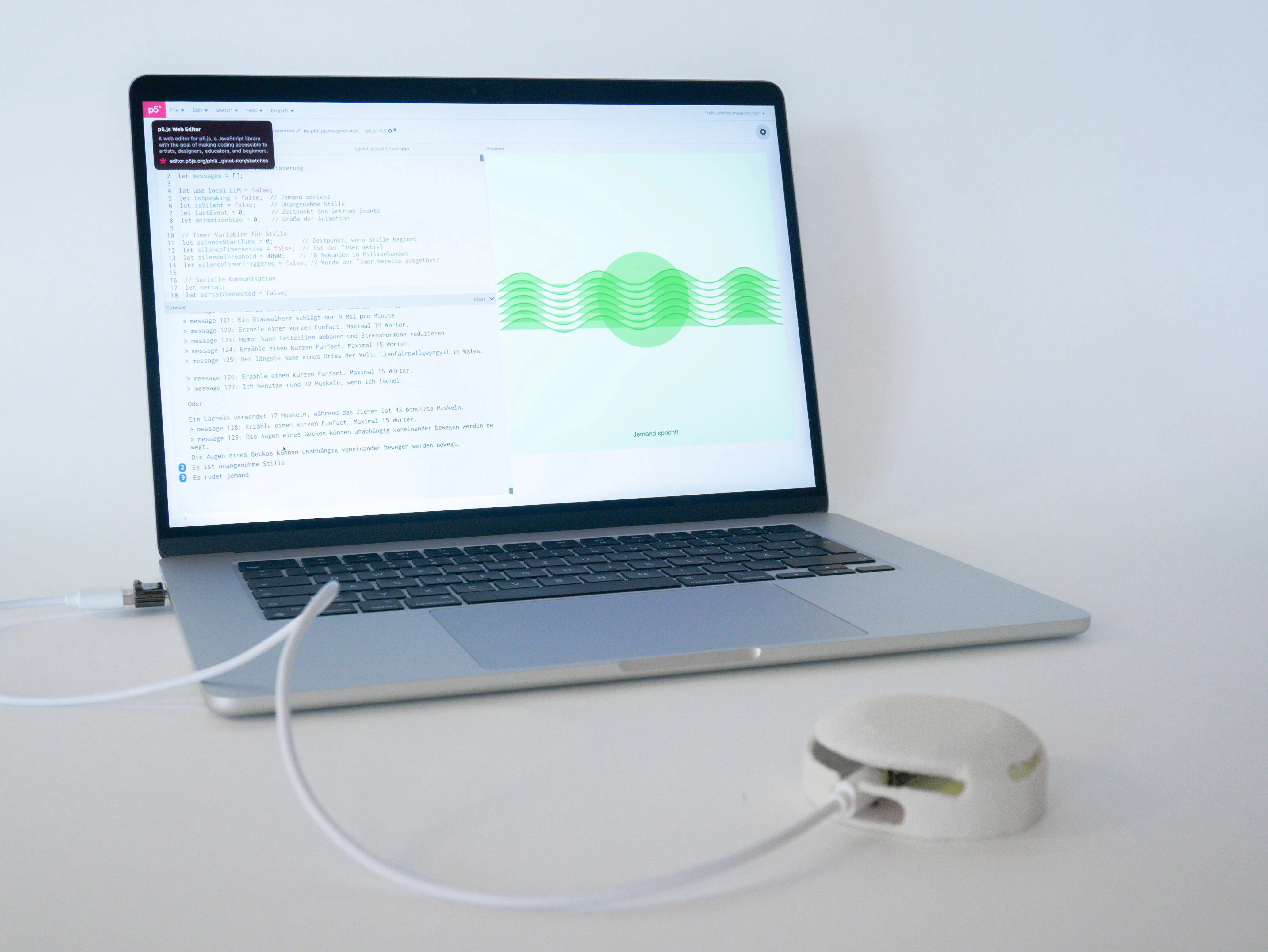 Social Spark prototype in action: Laptop displays real-time audio visualization of an ongoing conversation in the form of green waveforms. The laptop is connected to a round table device that detects conversational pauses.
